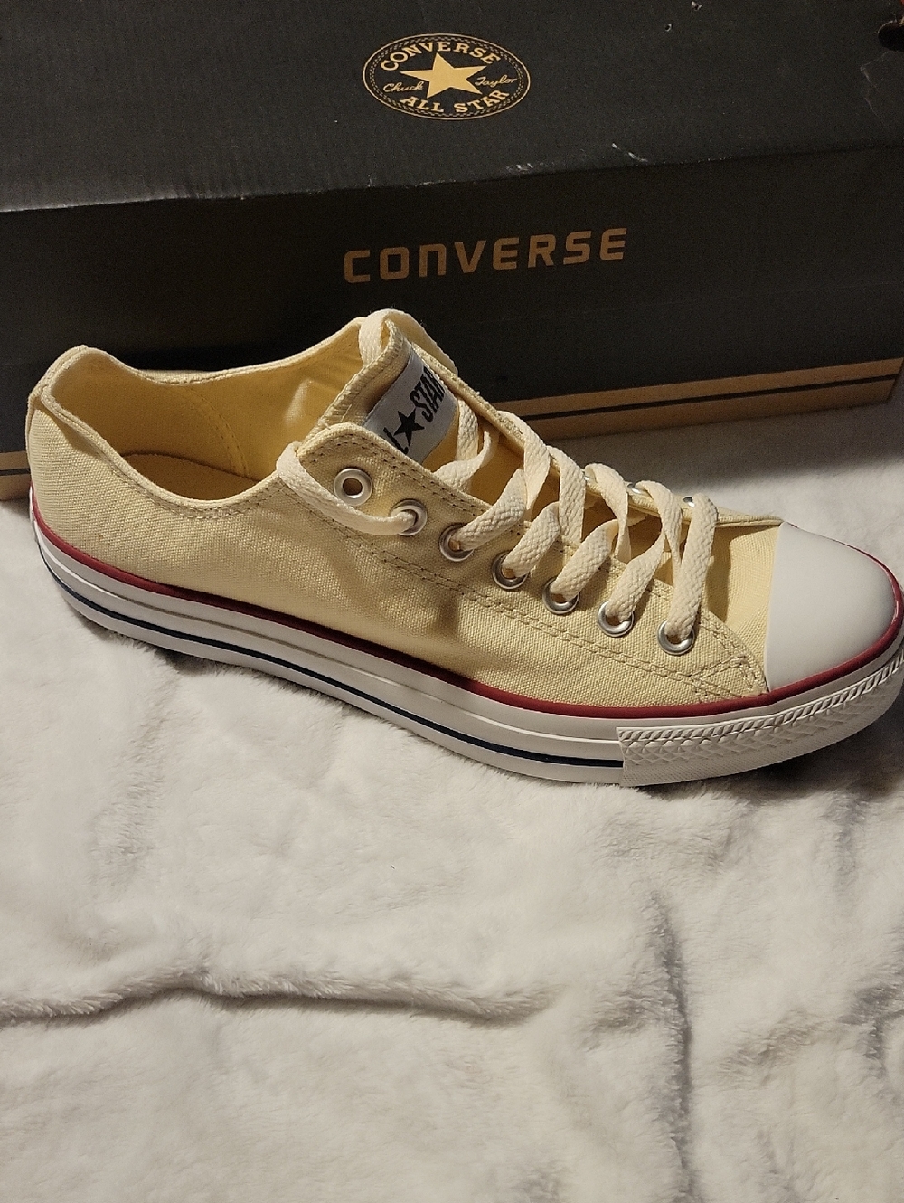 Converse Low Top Sneakers in Pale Yellow with Red Stripe